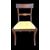 Four walnut chairs with geometric pattern decoration.