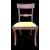 Four walnut chairs with geometric pattern decoration.