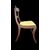 Four walnut chairs with geometric pattern decoration.