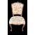 Four walnut chairs with floral pattern carvings.