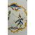 Piatto in maiolica decorato con personaggio in ambiente agreste.Manifattura Coppellotti.Lodi.