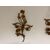 Three gilded metal sconces with floral motifs. 19th century