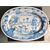 Large oval plate in blue monochrome majolica decorated with characters, architectures, mythological figures and plant motifs.Manufacture of Deruta.Master of the Regiment.     