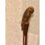 Wooden stick in a single piece with a knob representing a parrot.     