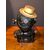 Piggy bank in antimony depicting dark brown with hat.     