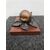 Pear-shaped bronze inkwell on marble base.     