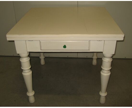 Extendable table with antique lacquered pulls     