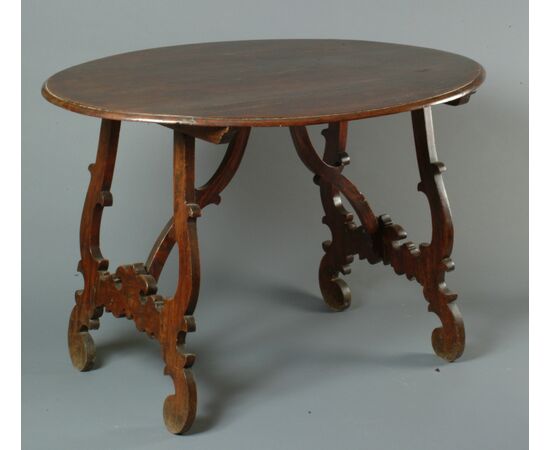 Marche, late 17th century, lyre-shaped center table in carved wood     