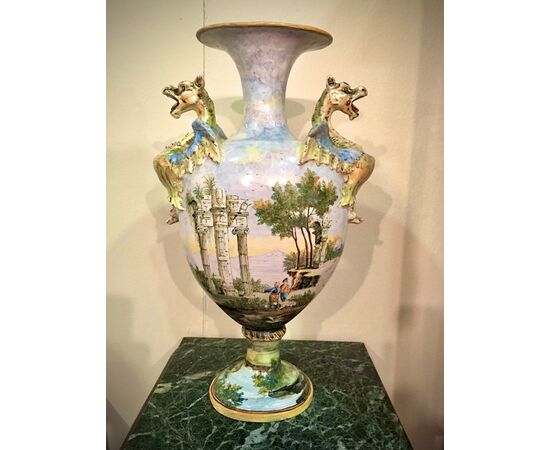 Pair of polychrome majolica vases decorated with landscapes and characters (Castelli style). Side grips in the shape of dragons. Angelo Minghetti. Bologna.     