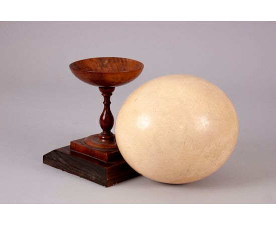 Ostrich egg on ancient wooden base     