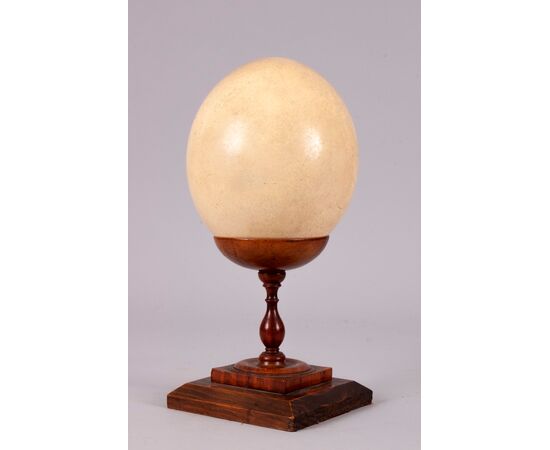 Ostrich egg on ancient wooden base     