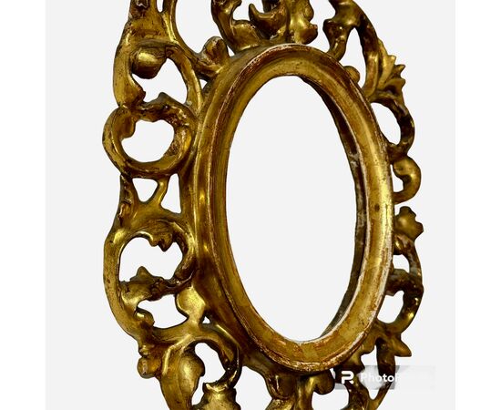 Cornice ovale in legno intagliato e dorato, Toscana XIX secolo. 
