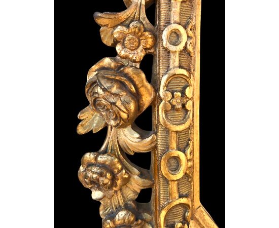 Cornice - specchiera in legno intagliato e dorato con motivi floreali e rocaille.Periodo direttorio.
