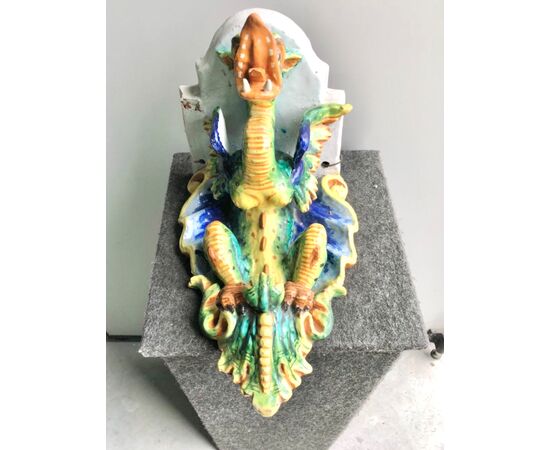 Majolica shelf with support in the shape of a winged dragon.Imola manufacture.     