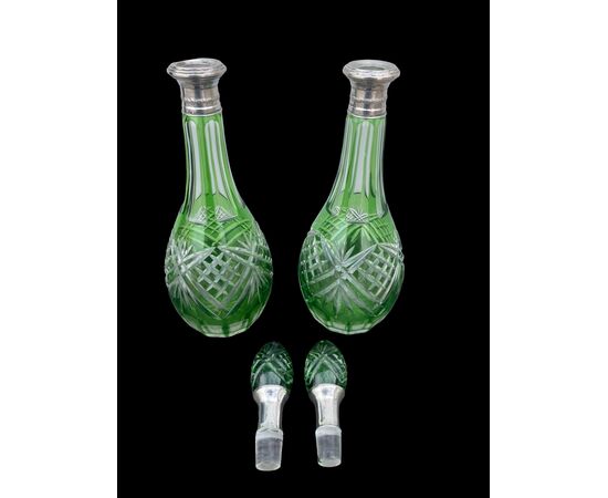 Coppie di bottiglie in cristallo verde molato con collo in argento.