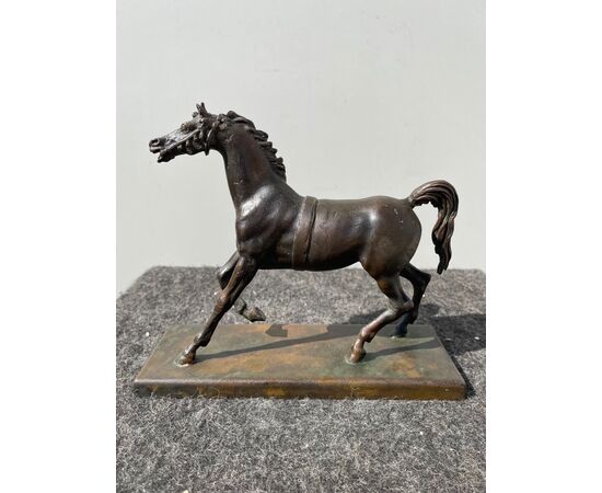 Bronze sculpture with base depicting a horse.     