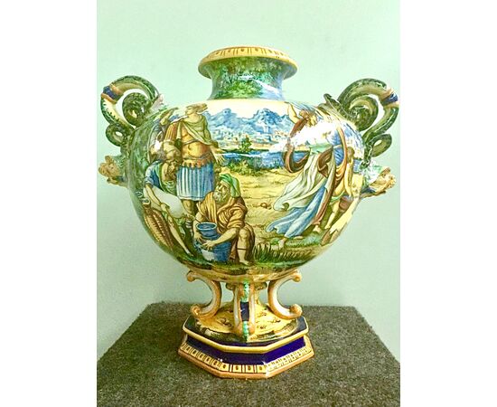 Globular vase in majolica with historiated decoration with lateral snakes and masks intakes.Fantechi manufacture, Signa.     
