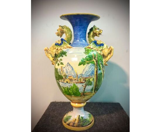 Majolica vase with lateral dragons grips and decorated with a bacchanal scene.Manifattura Minghetti.Bologna.     