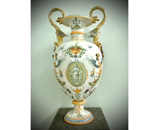 Large majolica vase with dragons handle and Raphaelesque and grotesque decoration with putto in central medallion.Ginori manufacture.     