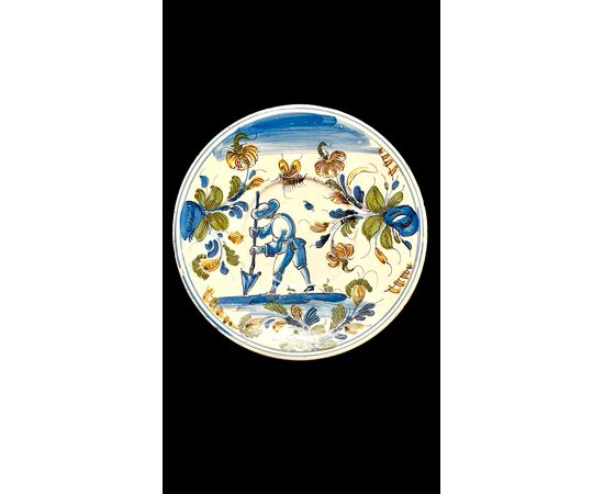 Piatto in maiolica con figura di contadino in ambiente agreste.Pavia.