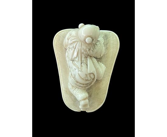 Netsuke in avorio raffigurante personaggio maschile.Giappone.