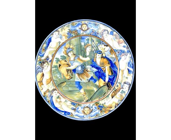 Piatto in maiolica decorato con scena mitologica e tesa a putti e mascherone.Castelli d’Abruzzo.Bottega Gentile. 