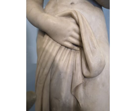 White marble statue with base, depicting Venus     