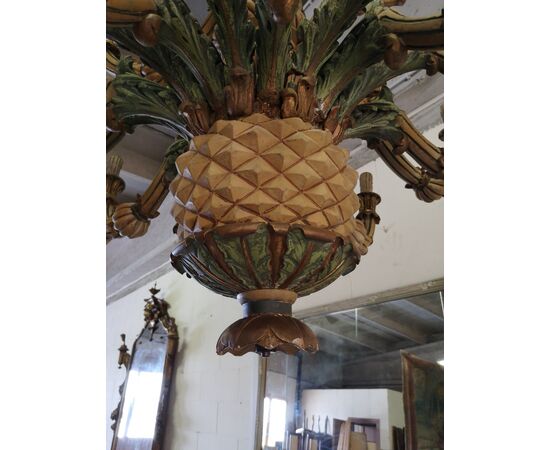 Large and particular chandelier in carved and lacquered wood     