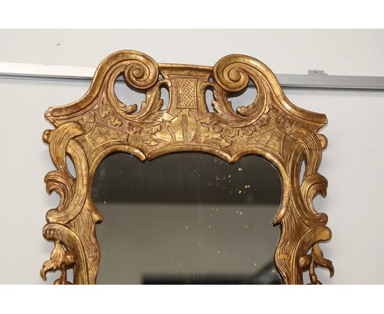 Shaped and carved gilded wooden mirror     