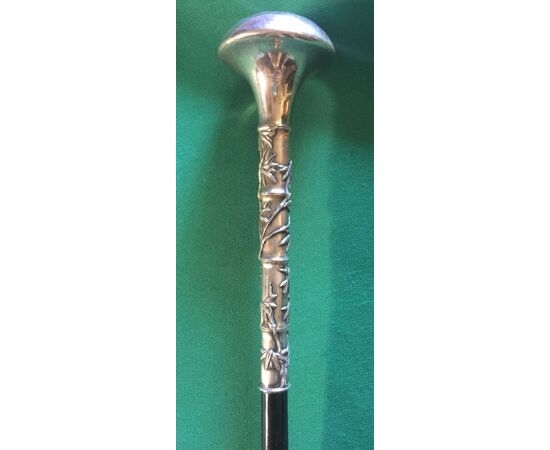 Walking stick with silver knob depicting a bamboo branch with leaves in relief. China.     
