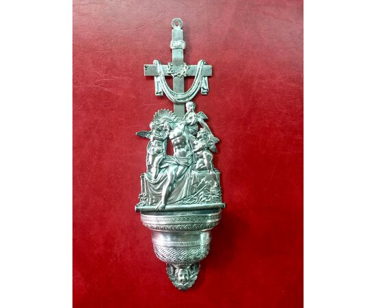 Holy water stoup in embossed silver with a scene of the deposition of Christ with angels.Punzone Lombardo-Veneto.     