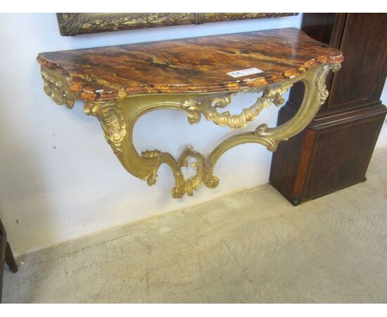 golden console with wooden floor marbled