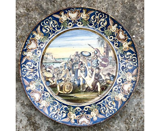Large majolica plate with decorated battle scene.     