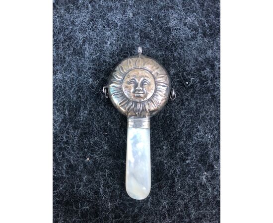 Silver rattle for children depicting the sun. Mother of pearl handle. England.     