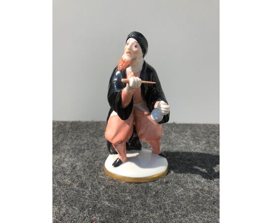 Statuina in porcellana con figura maschile con pugnale e sacchetto di denaro.Ginori