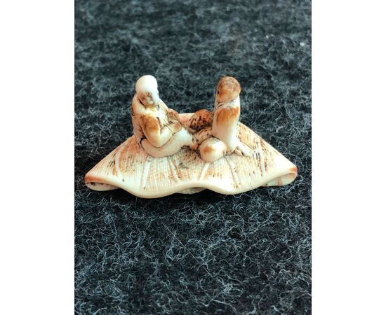 Netsuke &#39;in ivory depicting two characters sitting on a lotus leaf.Japan     