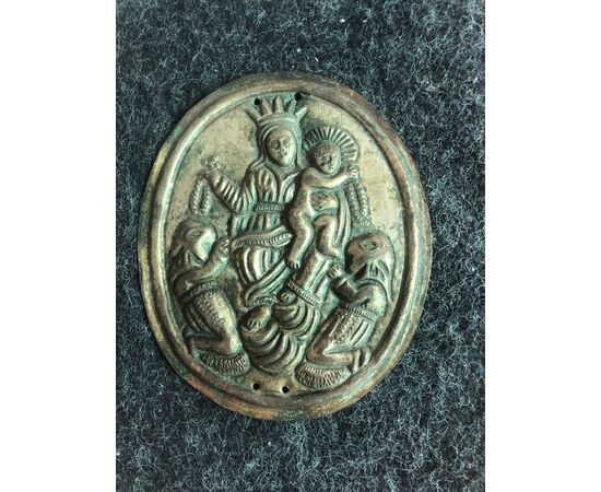 Brass tablecloth depicting the Madonna with Child and two hooded characters. Brotherhood of the Rosary.     