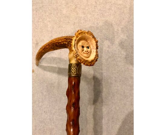 Stick with handle. Made of deer bone with a carved face.     