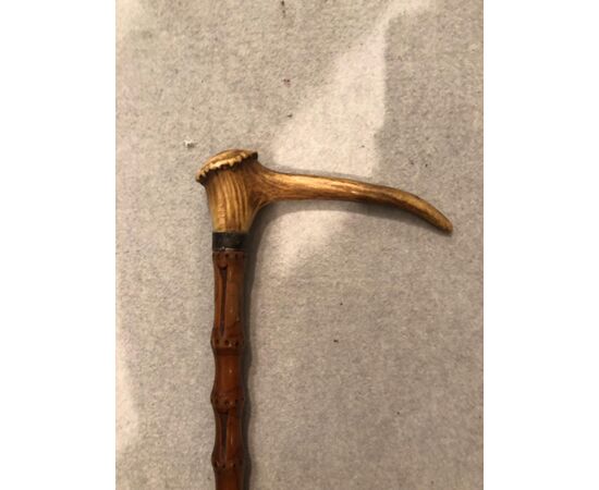 Animated stick with deer horn knob with corkscrew.     