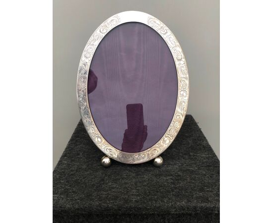 Picture frame in silver with floral decoration. Sterling punch. United States.     