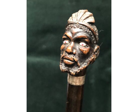Stick with wooden knob depicting African male figure.Italy     