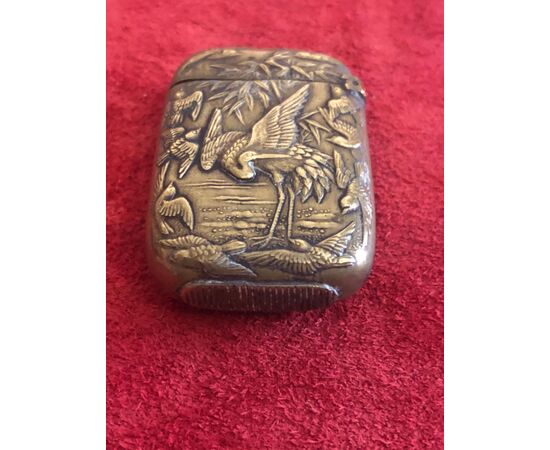 Brass matchbox with herons and birds in an art nouveau style lakeside setting.     