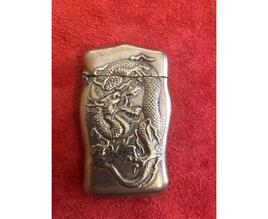 Silver matchbox without punch with dragon decoration on both sides.     