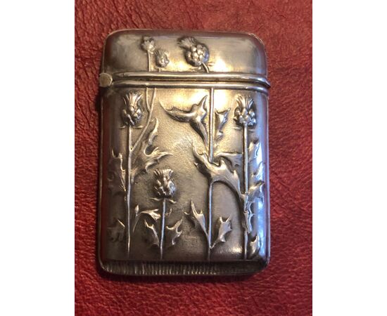 Silver matchbox with art nouveau thistle floral decoration.     