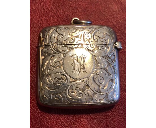 Silver matchbox with rocaille decoration with NV initials England.     
