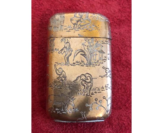 Vermeille silver matchbox without punch with oriental village scenes.     