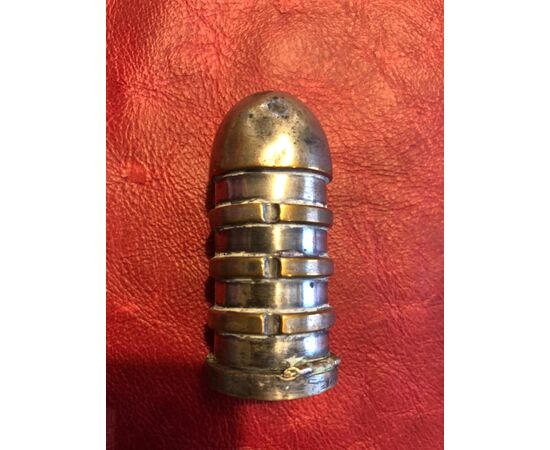 Silver plated copper matchbox in the shape of a grooved ogive.     