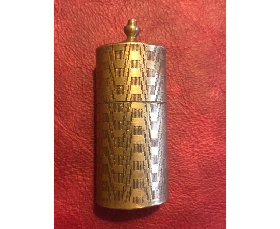 Cylindrical brass matchbox with geometric upholstery decorations.Vesta, England.     