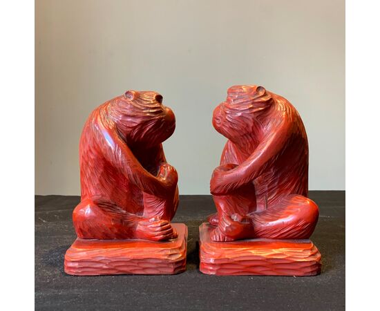 Red bookends in the shape of monkeys     