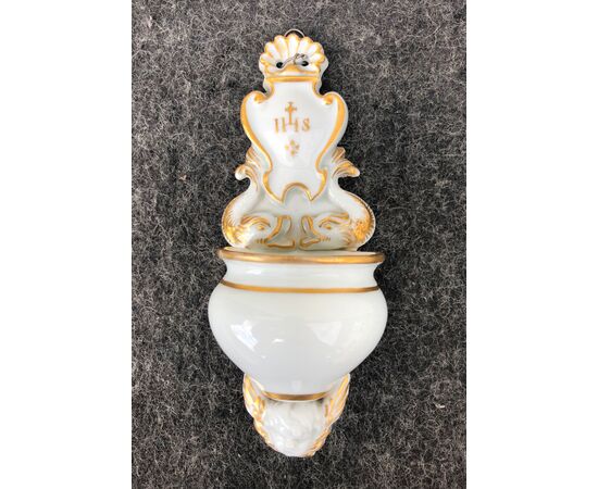 Holy water stoup in white and gold porcelain with tritons, putto and Bernardinian symbol Italy.     